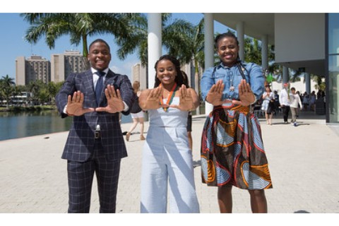 students making the U symbol with their hands